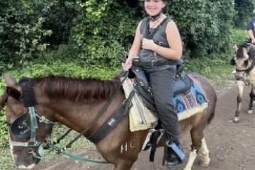 a person riding a horse on a dirt road