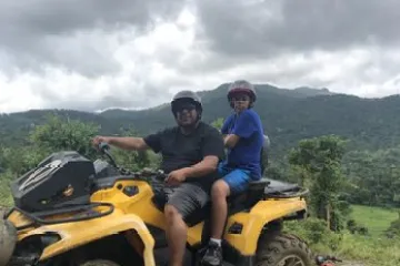 a man riding a motorcycle down a dirt road
