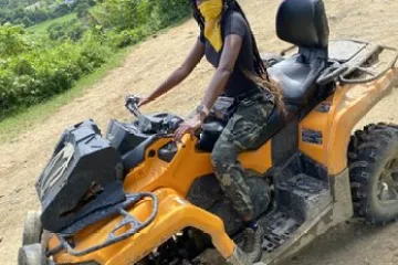 a motorcycle parked on the side of a dirt road