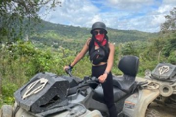 a man riding a motorcycle down a dirt road