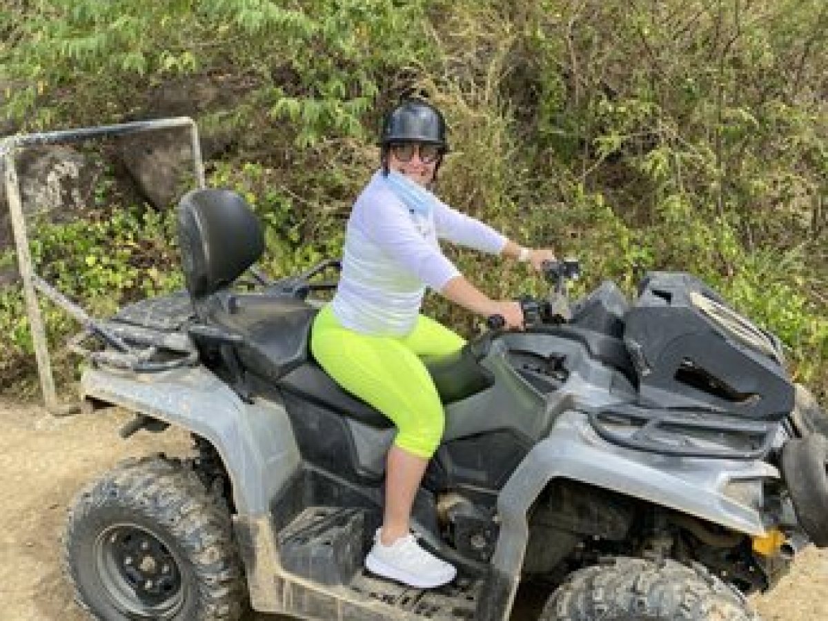 a man riding a motorcycle down a dirt road