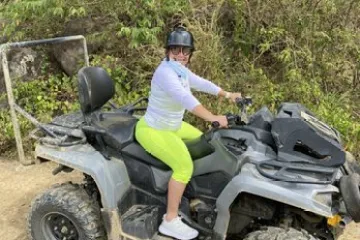 a man riding a motorcycle down a dirt road