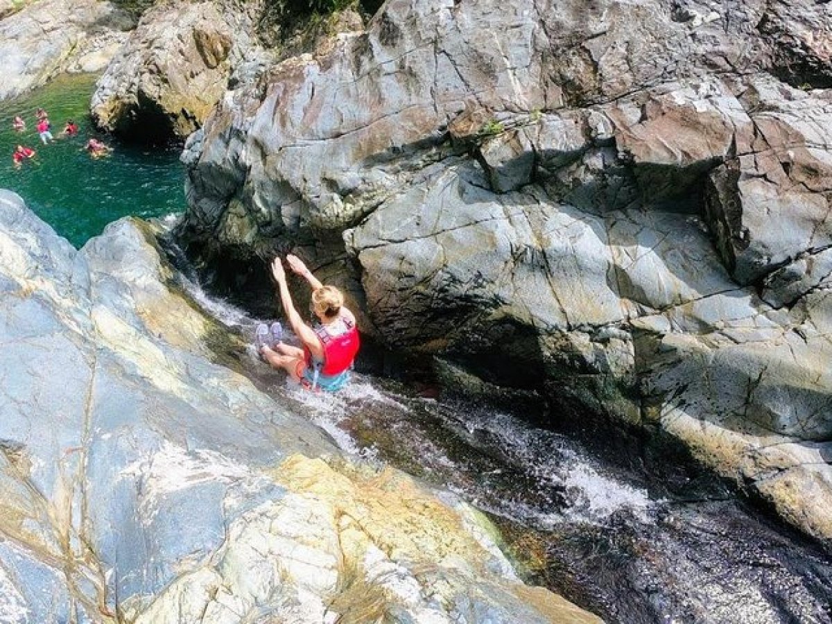 a person swimming in a rocky area