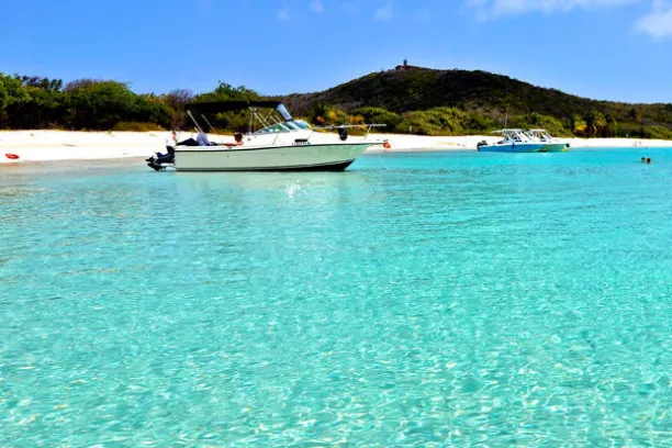 a blue and white boat sitting next to a body of water