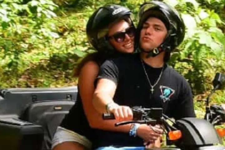 a person riding on the back of an atv