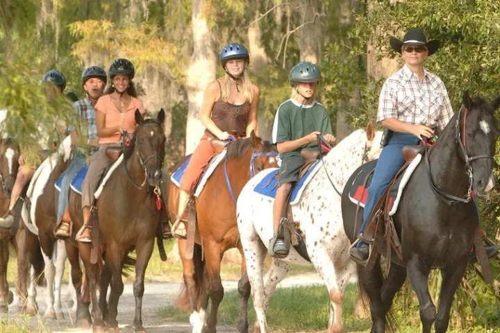 a group of people riding horses