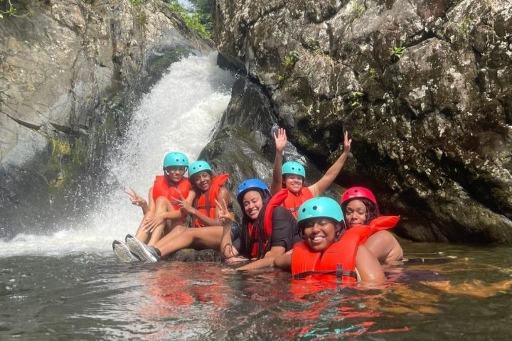 a group of people on a raft in a body of water