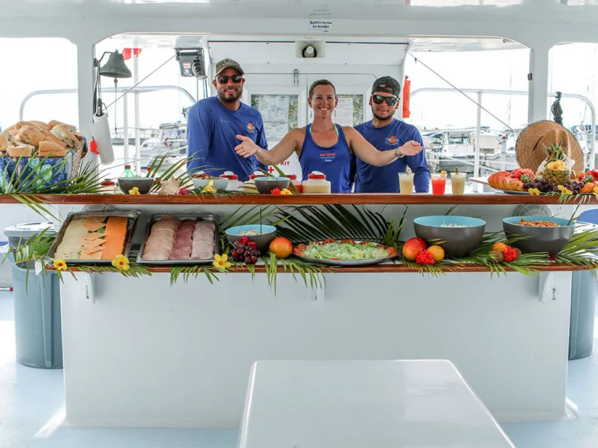 a group of people preparing food in a kitchen