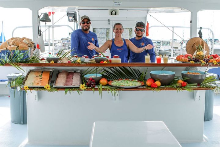 a group of people preparing food in a kitchen
