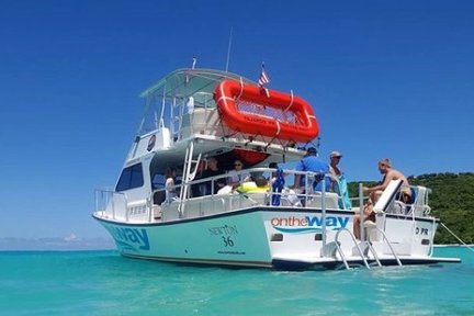 a blue and white boat sitting next to a body of water