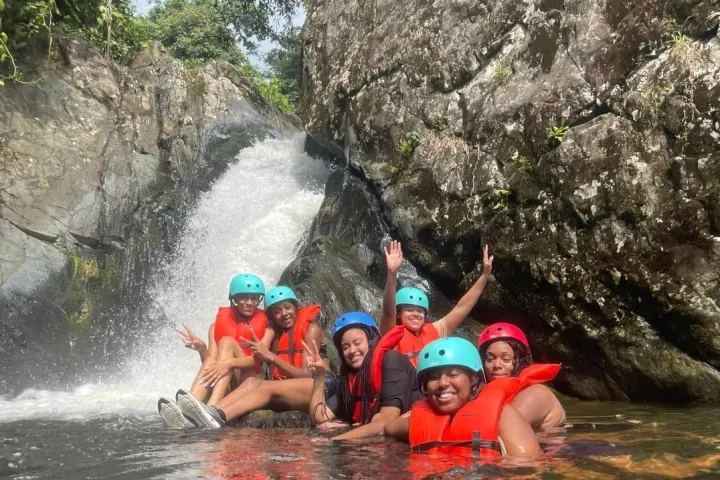 a group of people on a raft in a body of water