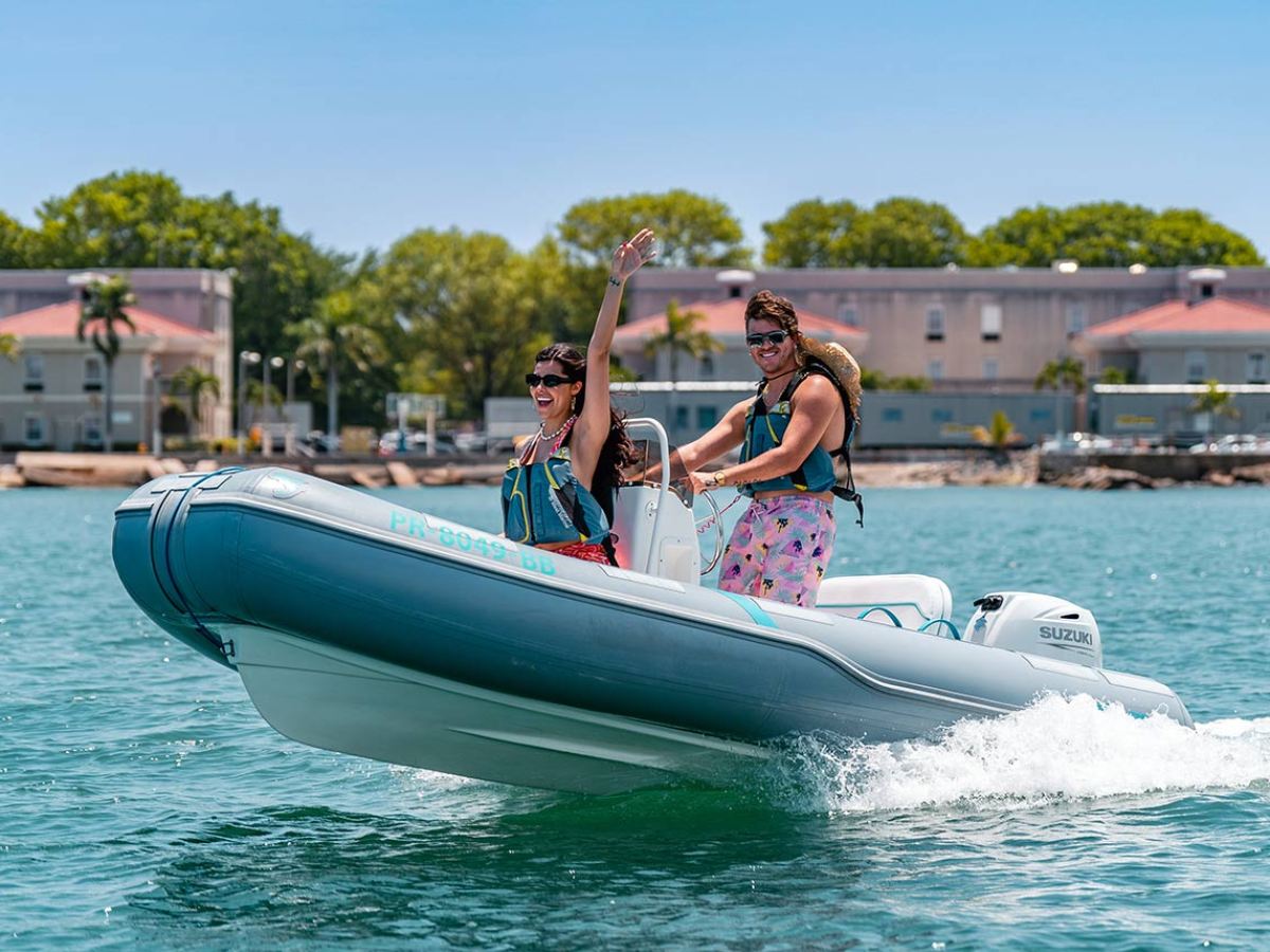 a person riding on the back of a boat in the water