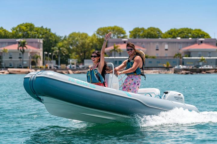 a person riding on the back of a boat in the water