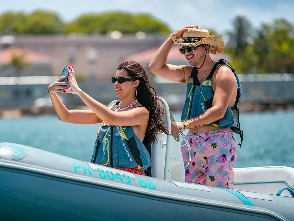 a woman riding on the back of a boat
