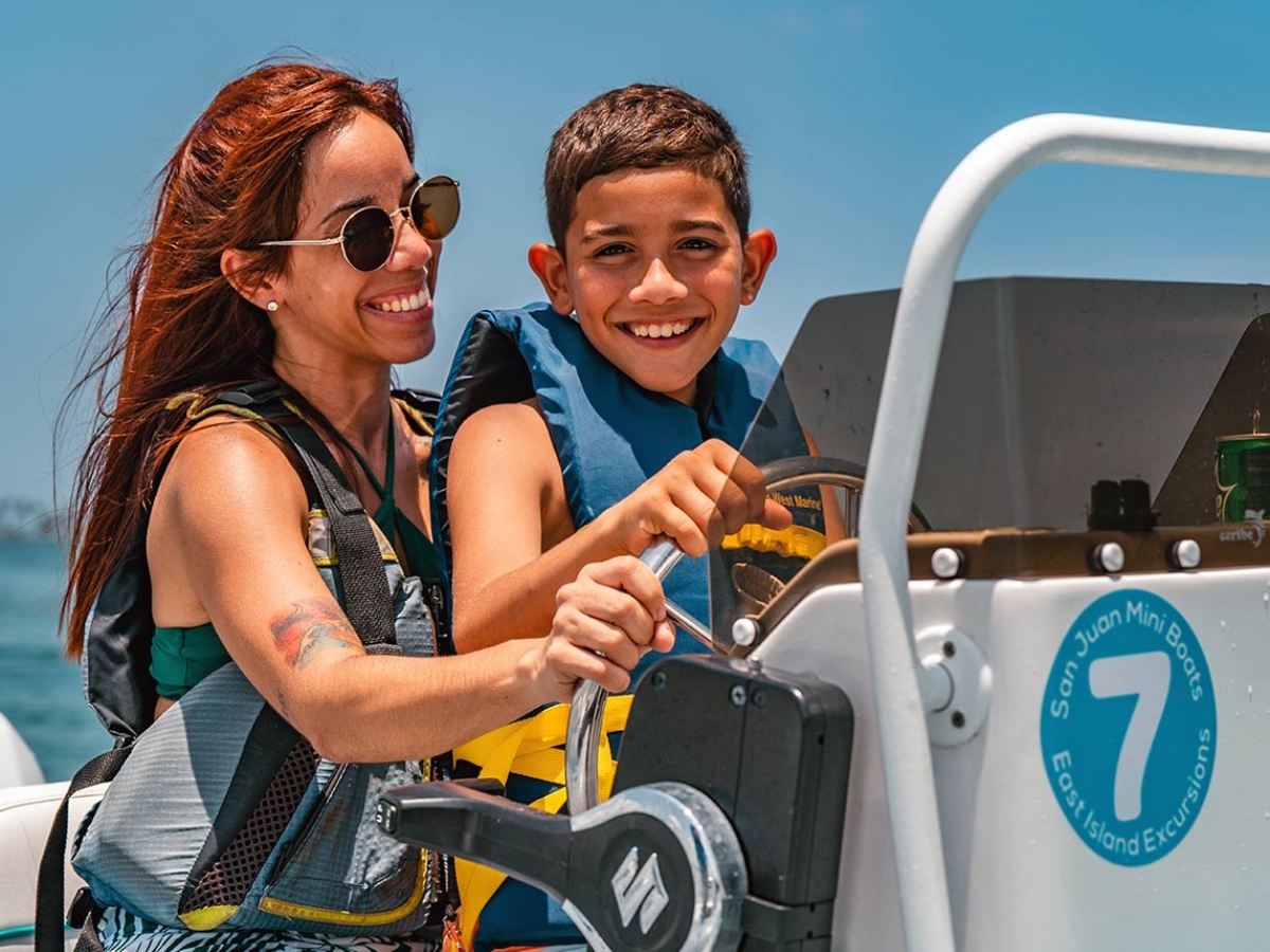 a woman in sunglasses sitting in a parking lot