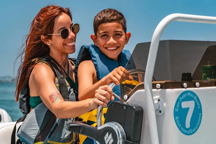 a woman in sunglasses sitting in a parking lot