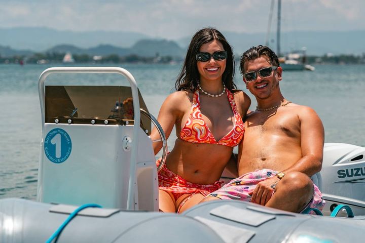 a man sitting on a boat in the water