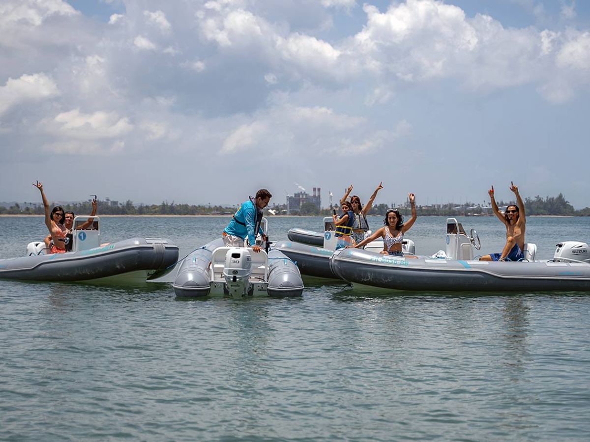 a group of people in a small boat in a body of water