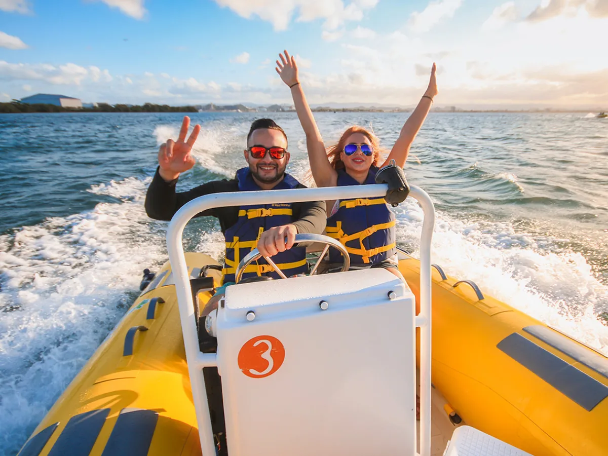 a person riding on the back of a boat in the water