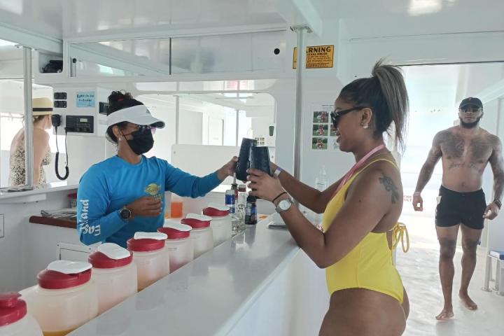a group of people standing in a kitchen