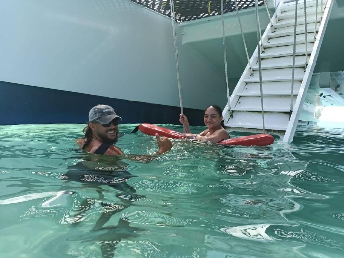 a group of people swimming in a pool of water