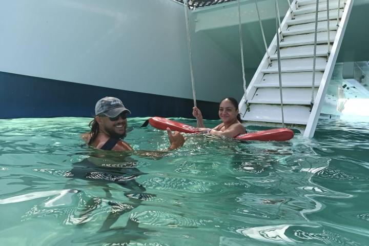 a group of people swimming in a pool of water