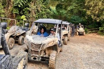 a group of people riding on the back of a truck