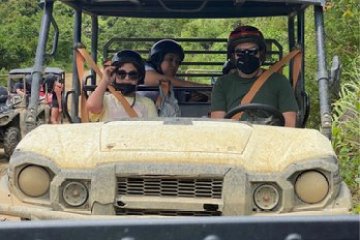 a group of people riding on the back of a truck