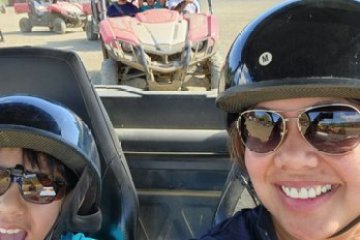 a woman wearing a hat and sunglasses