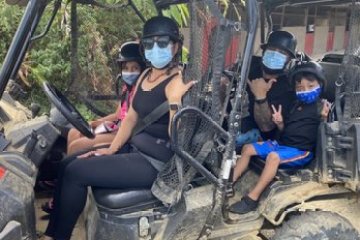 a group of people riding on the back of a truck