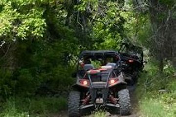 a truck driving down a dirt road