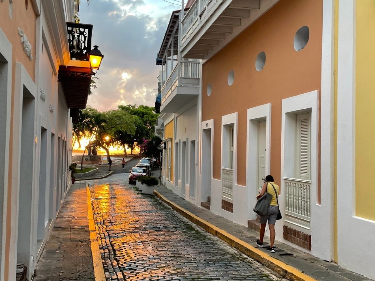 a person walking down a sidewalk next to a building