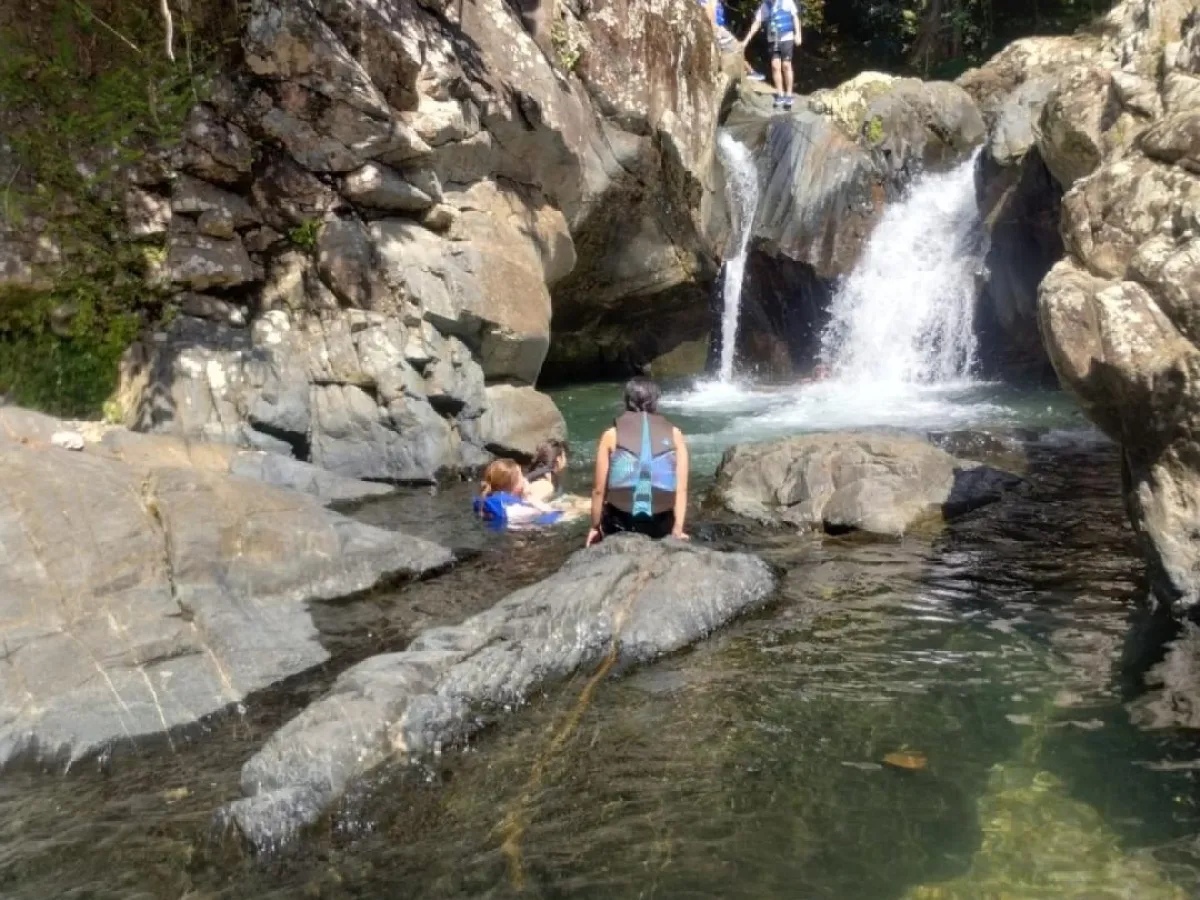 a man standing next to a waterfall