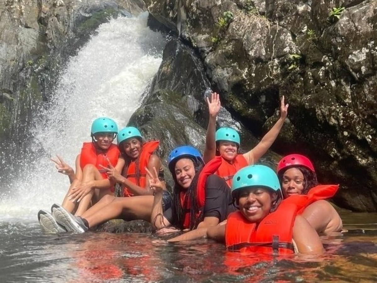 a group of people riding on a raft in a pool of water