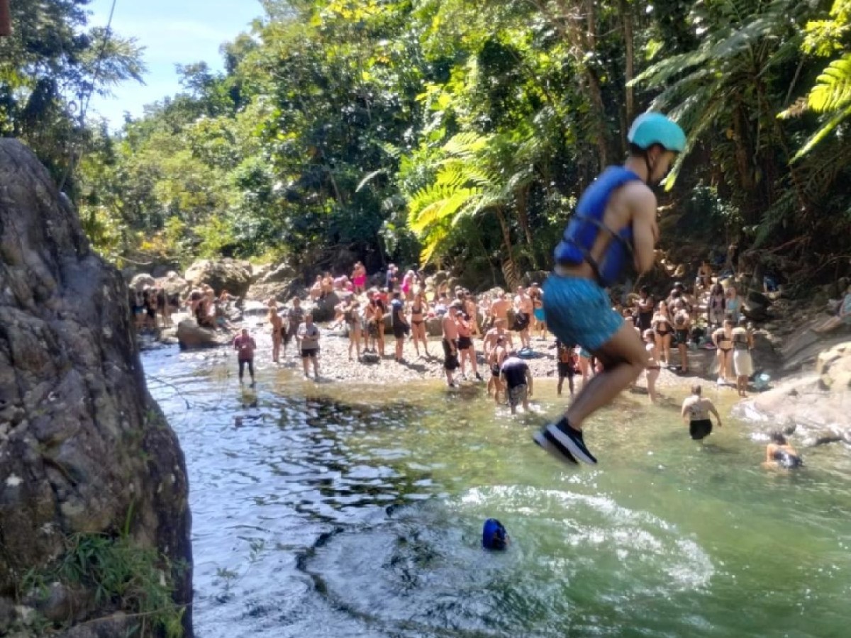 a man riding a surfboard on top of a rock
