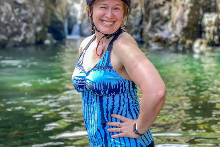 a person standing next to a body of water