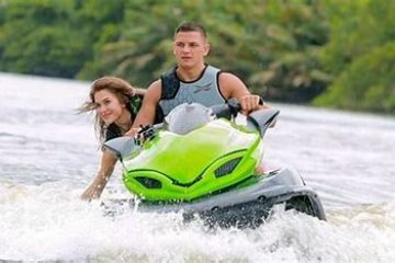 a man riding a wave on top of a body of water