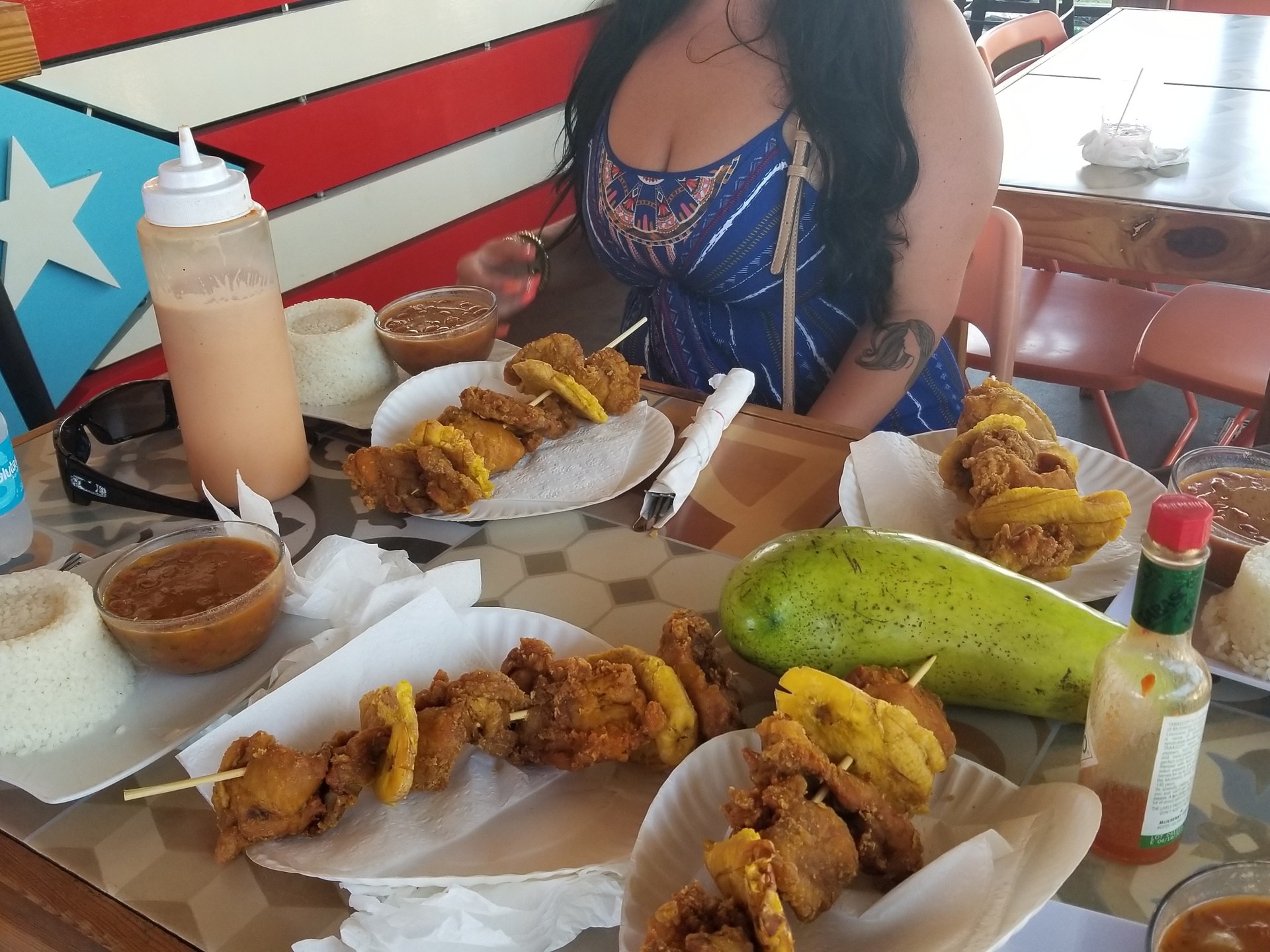 a woman sitting at a table with a plate of food