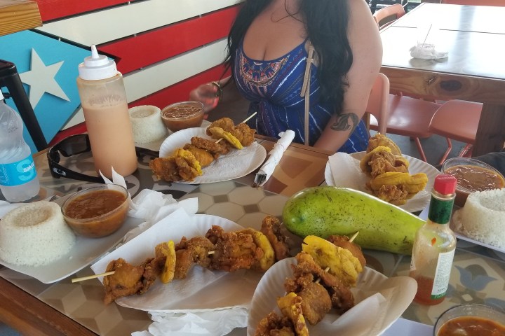 a woman sitting at a table with a plate of food