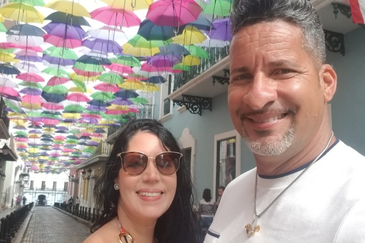 a man and a woman holding a colorful umbrella