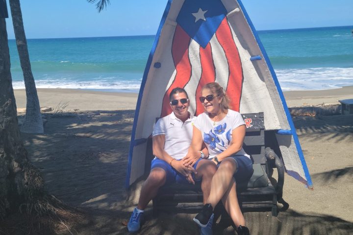a man sitting on a beach posing for the camera