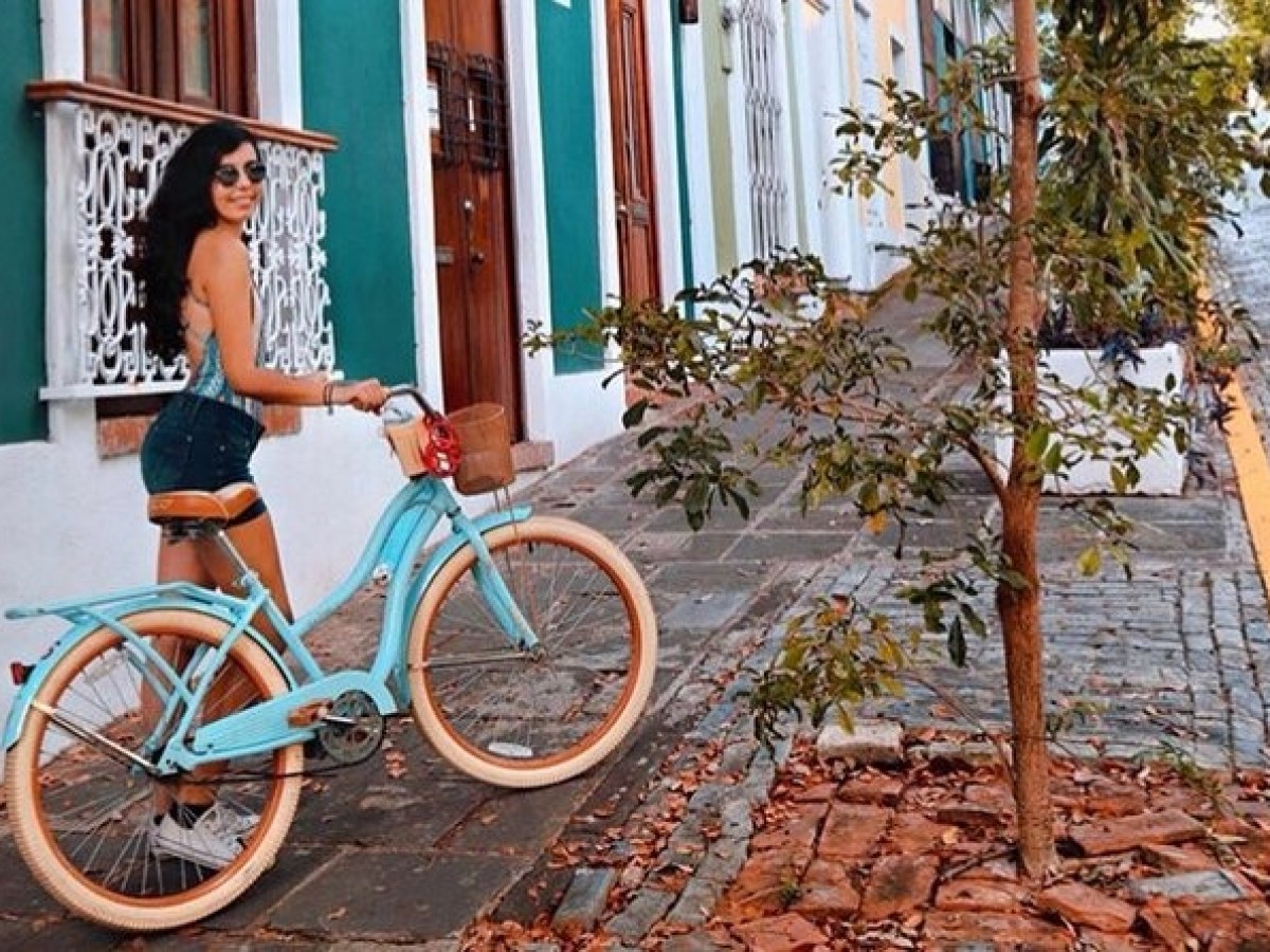 a person with a bicycle in front of a building