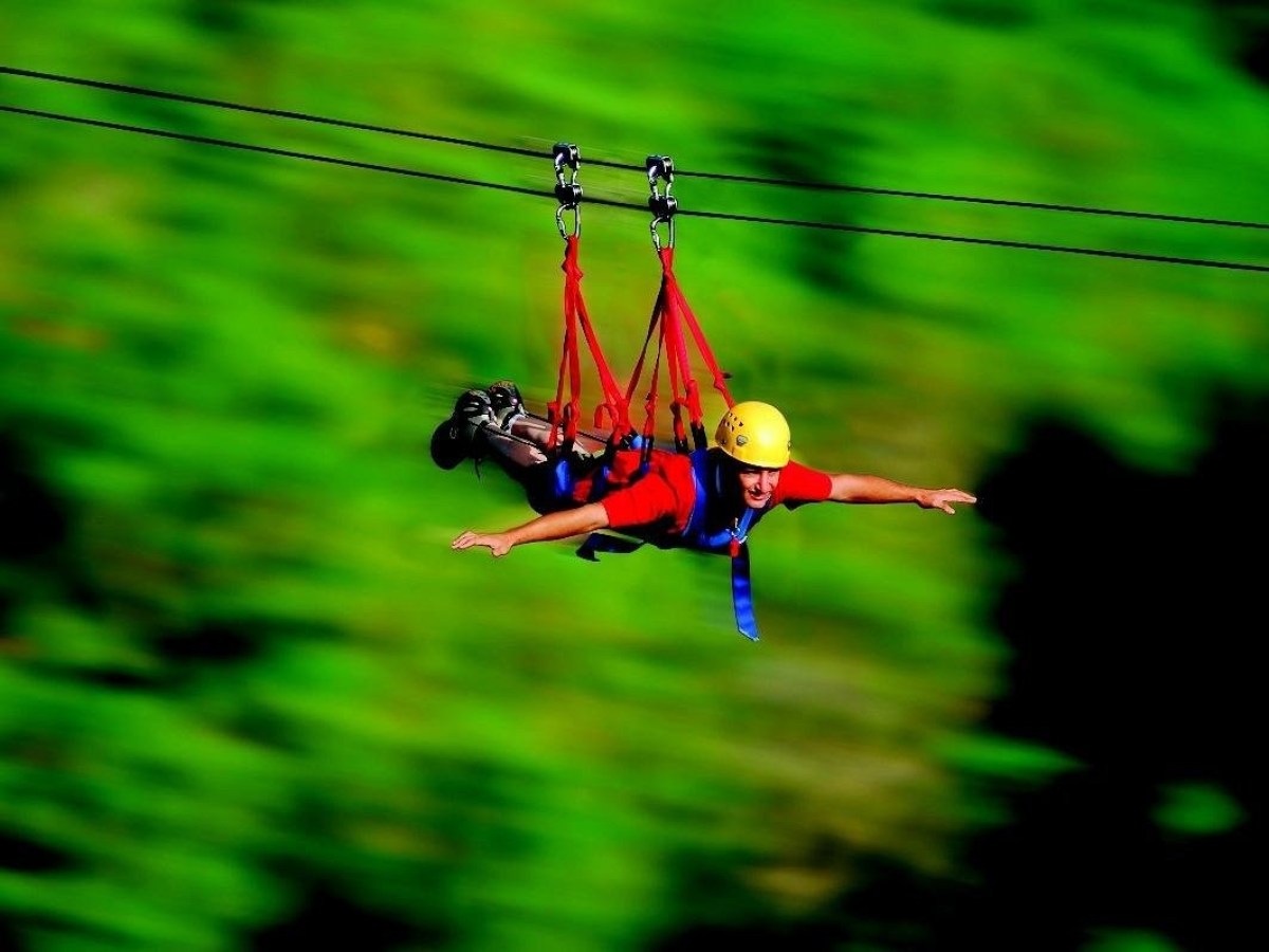 a person riding on top of a grass covered field