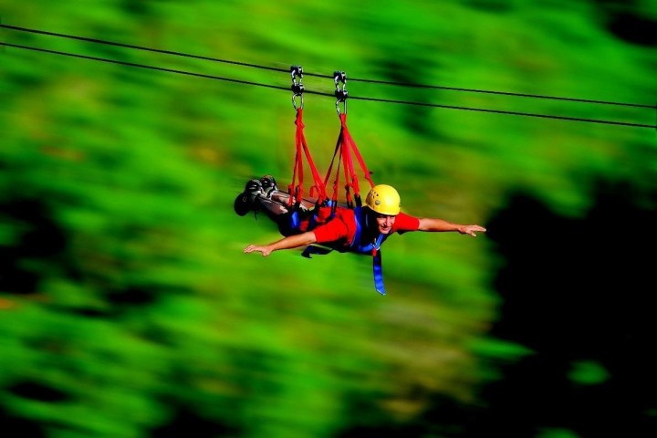 a person riding on top of a grass covered field