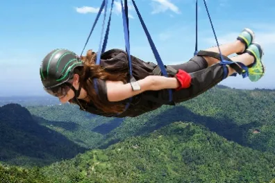 a man holding a kite in a body of water