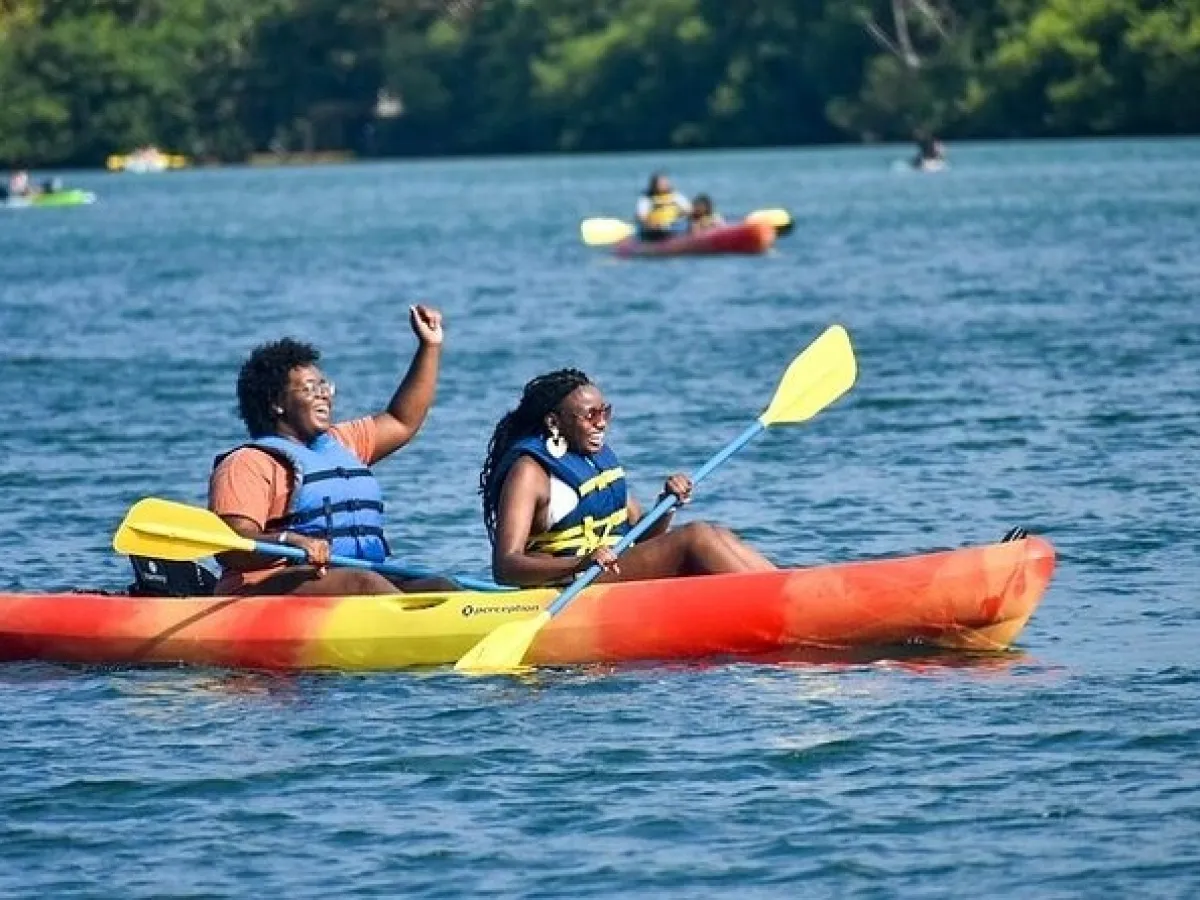 a man riding on the back of a boat in a body of water
