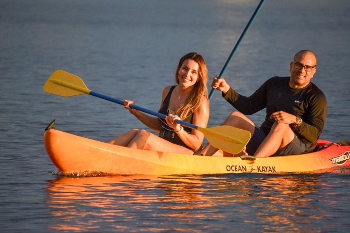 a person riding on the back of a boat in the water