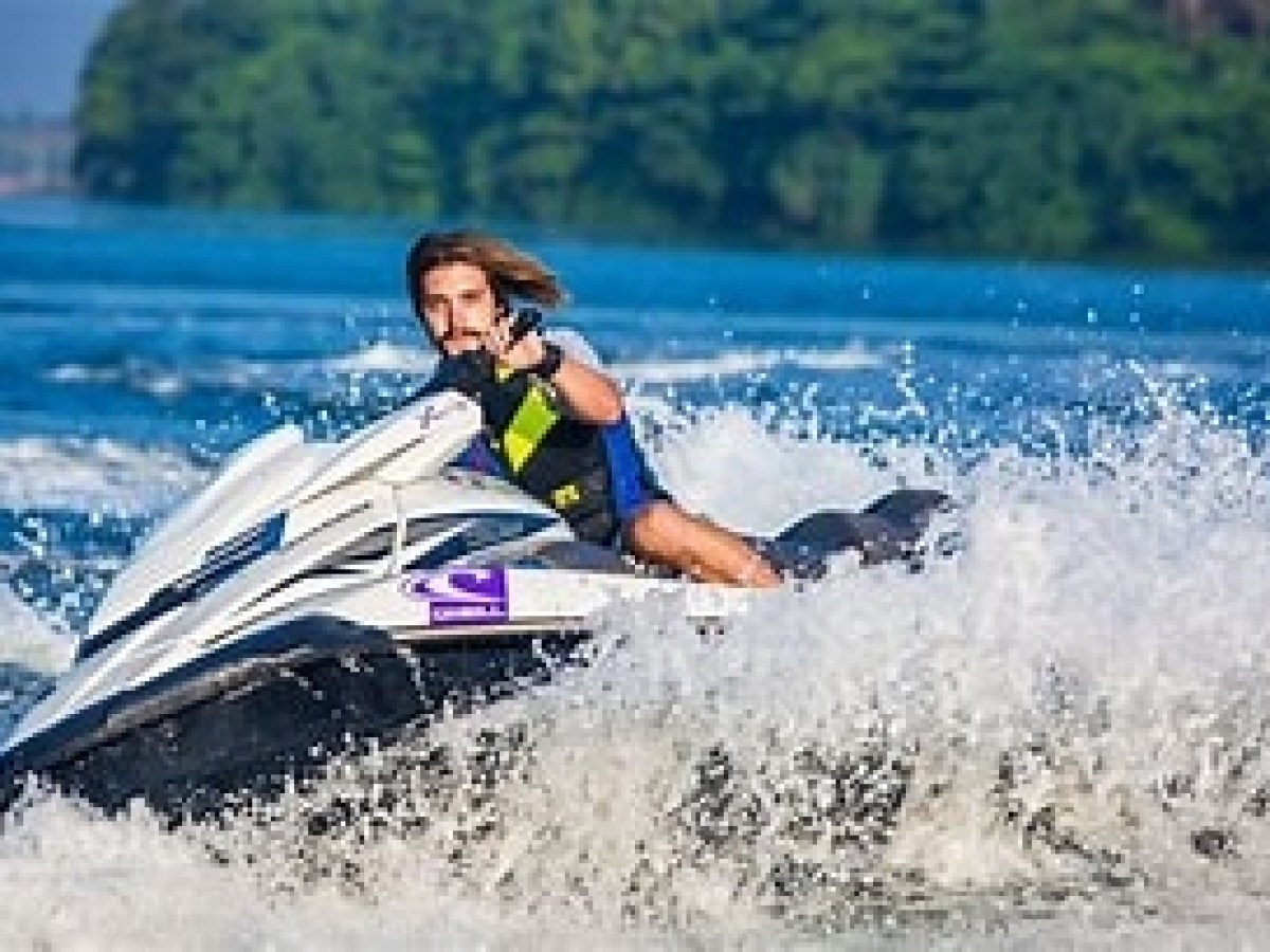 a man riding a wave on a surf board on a body of water