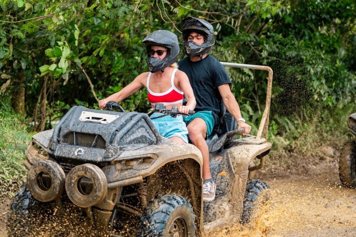 a man riding a bike down a dirt road