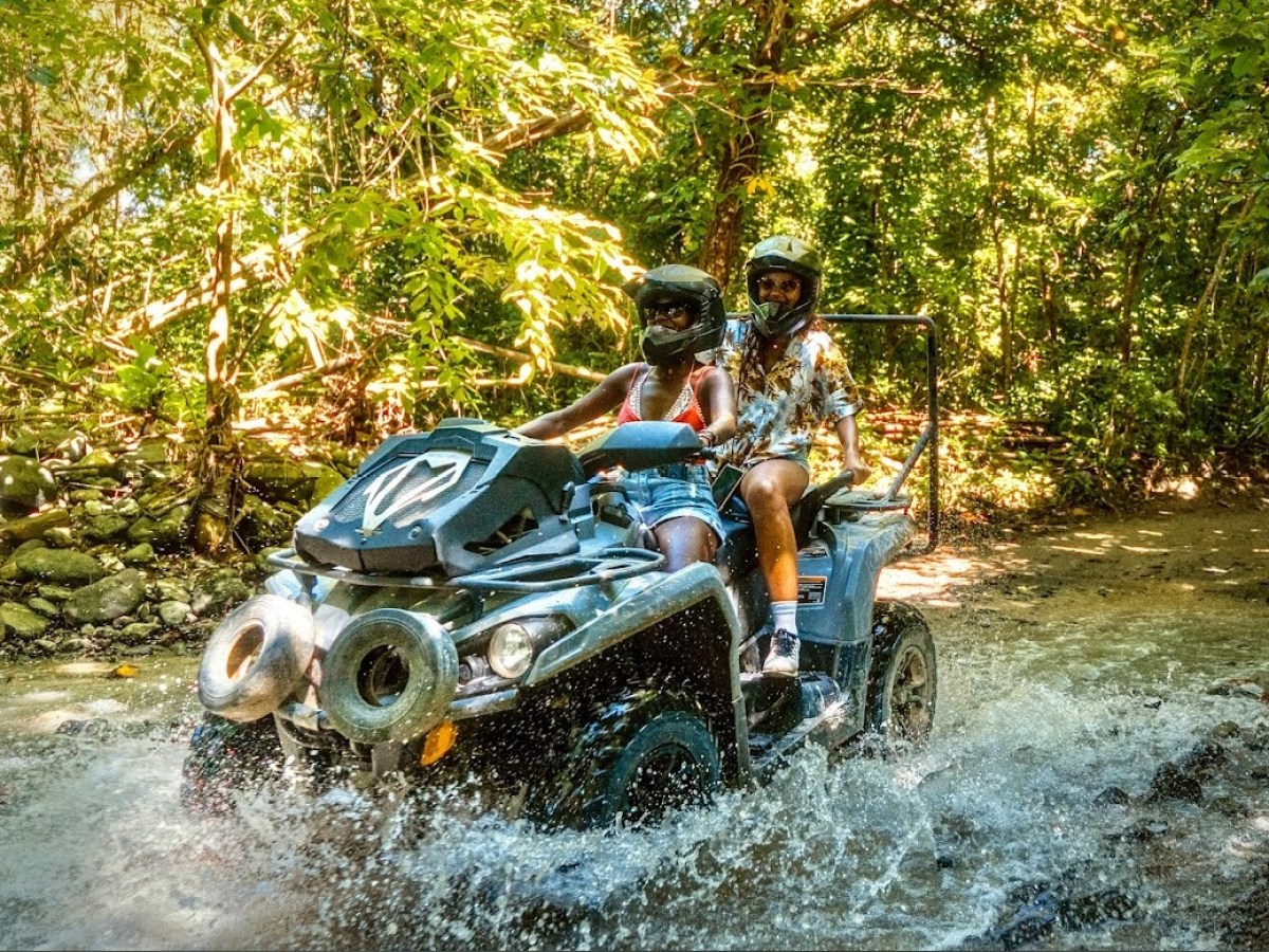 a man riding a motorcycle down a river